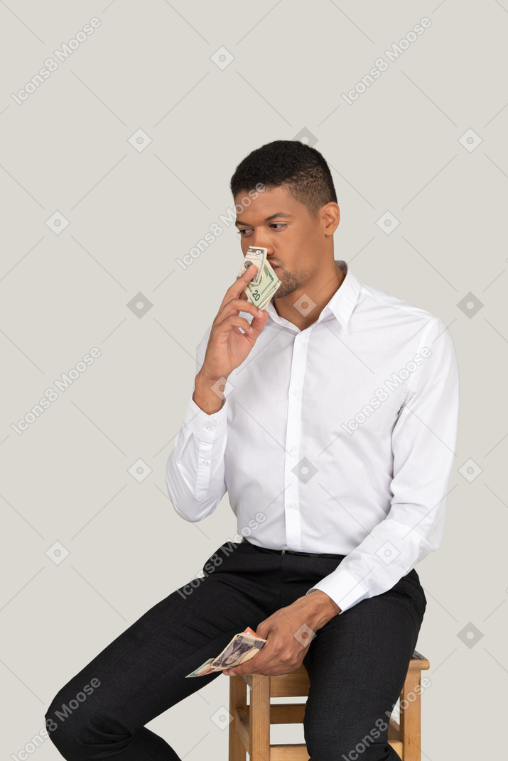 Man smelling banknotes