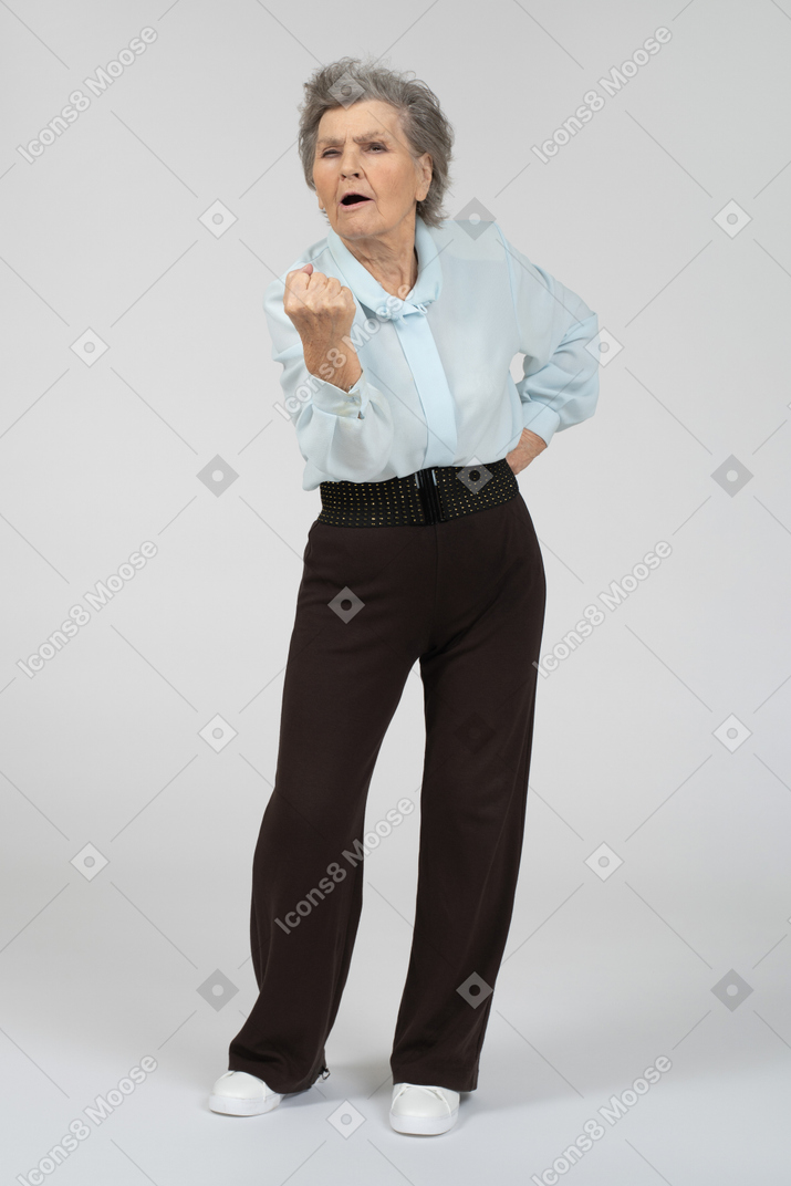Old lady threatening with fist