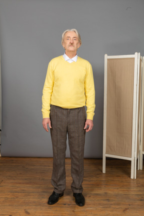 Front view of an unemotional old man looking at camera