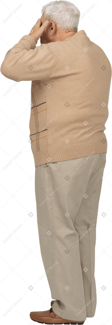 Old man in casual clothes covering eyes with hands