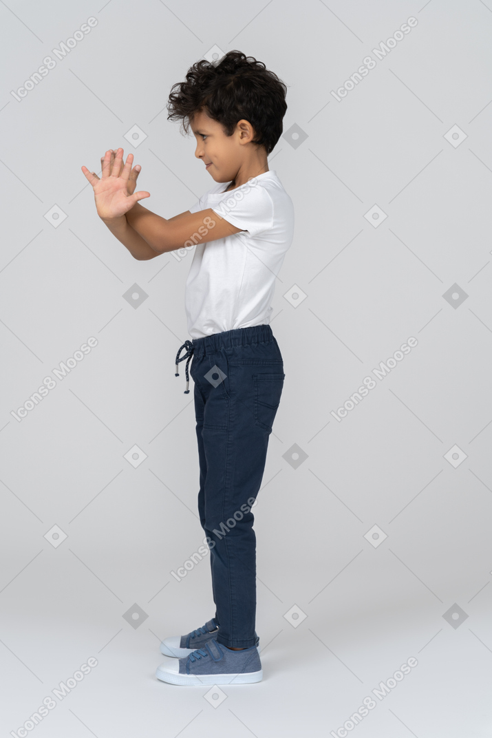 A boy gesturing enough sign