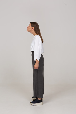 Side view of a young lady in office clothing outstretching her neck