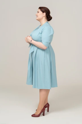 Woman in blue dress posing in profile