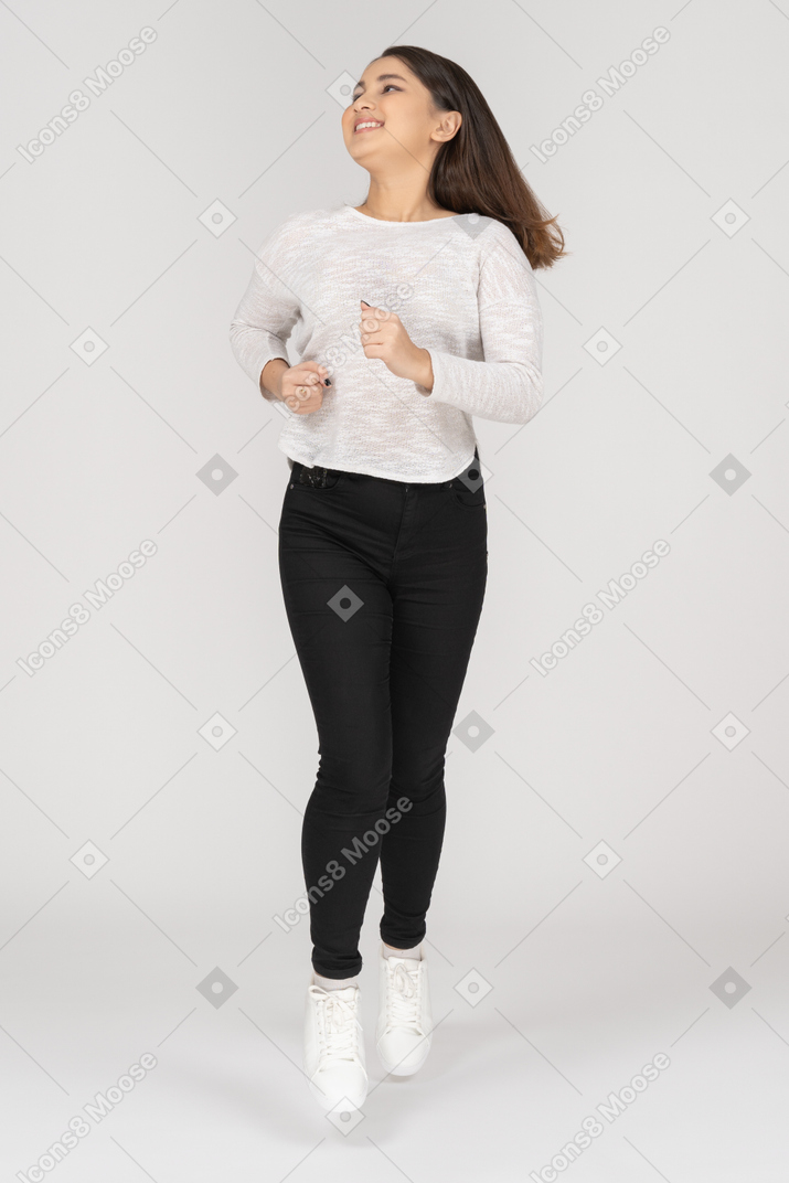 Front view of a young running indian female in casual clothes