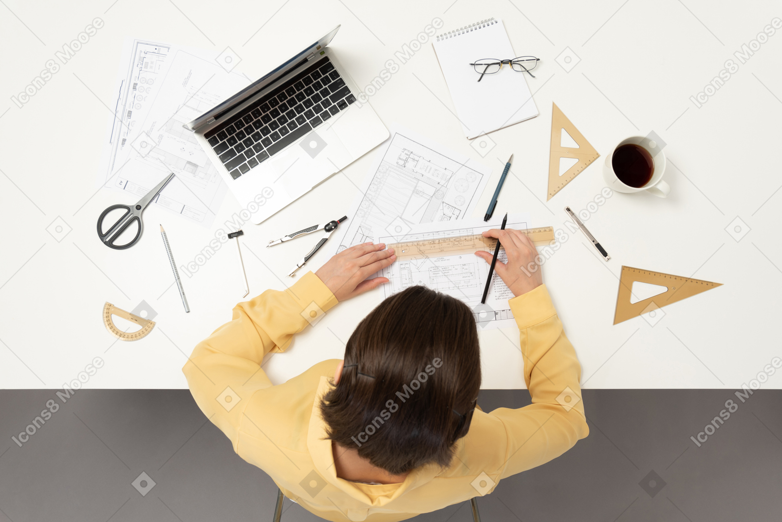 A female architect working on architectural drawings