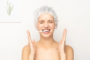 Woman holding syringe with her teeth