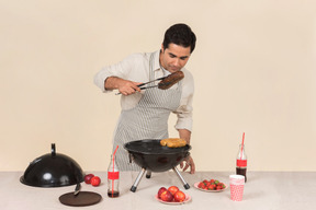 Young caucasian man preparing bbq