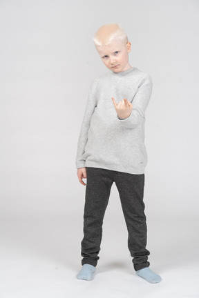 Little boy making rock gesture