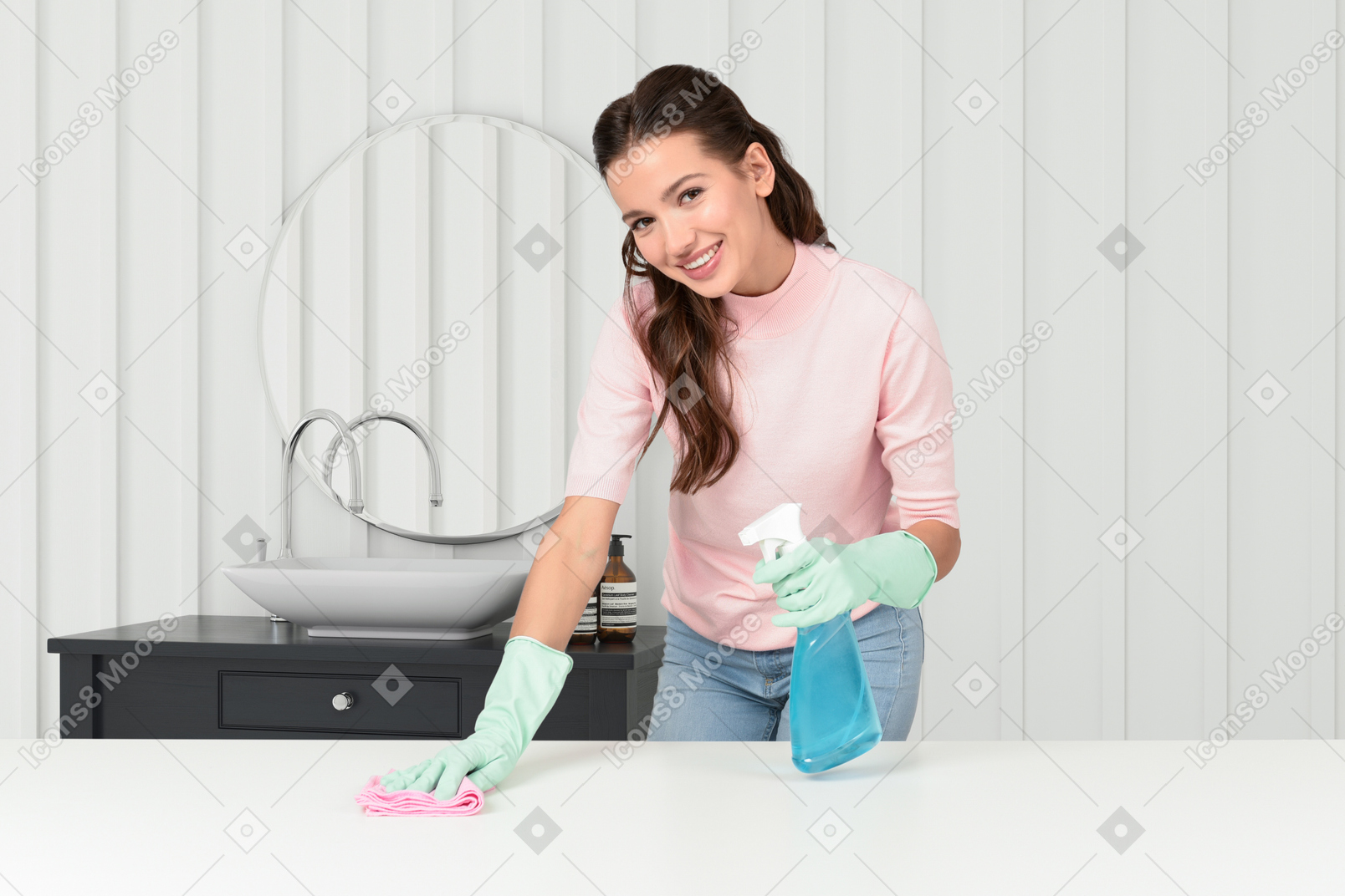 A woman in a pink shirt and green gloves cleaning a table