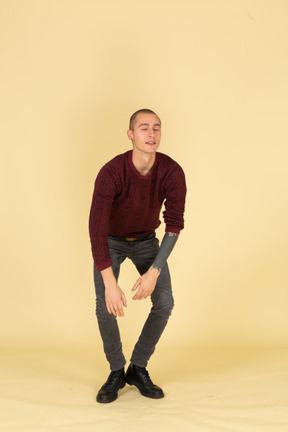 Front view of a sleepy young man leaning forward