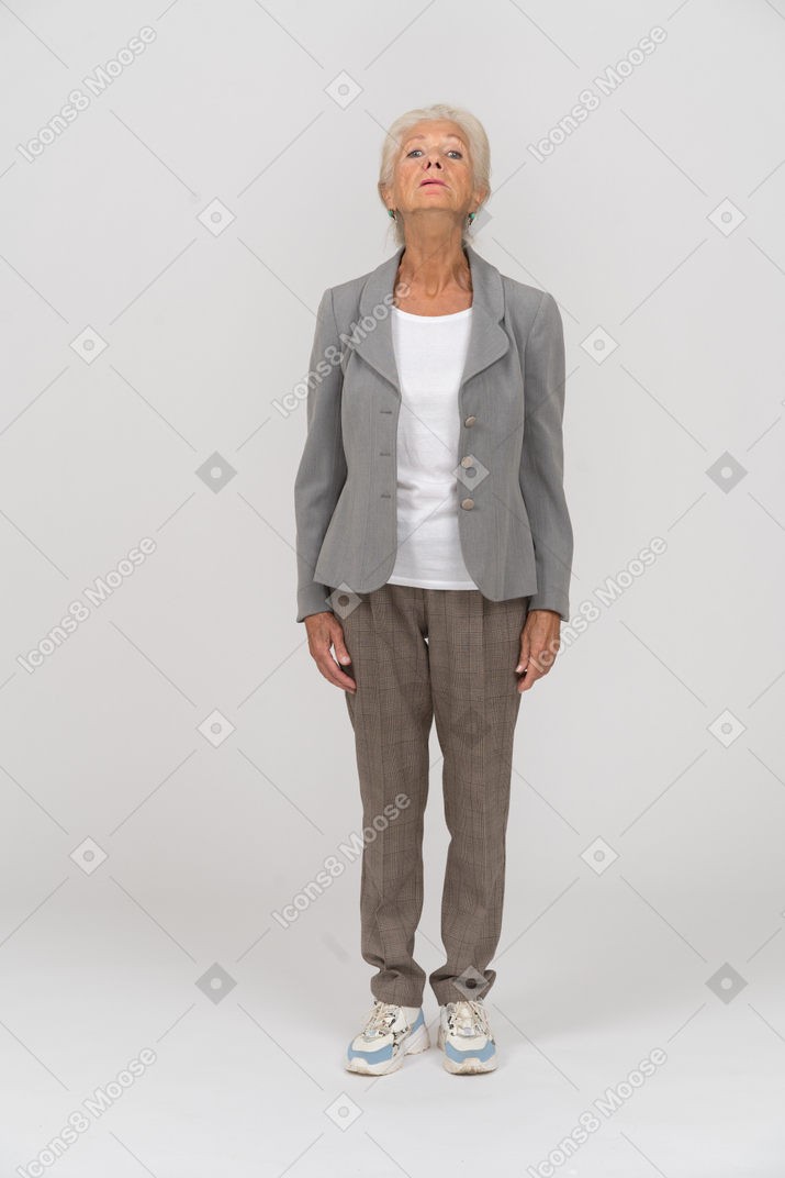 Front view of an old woman in suit looking up
