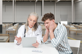 Doctor and patient looking at tablet