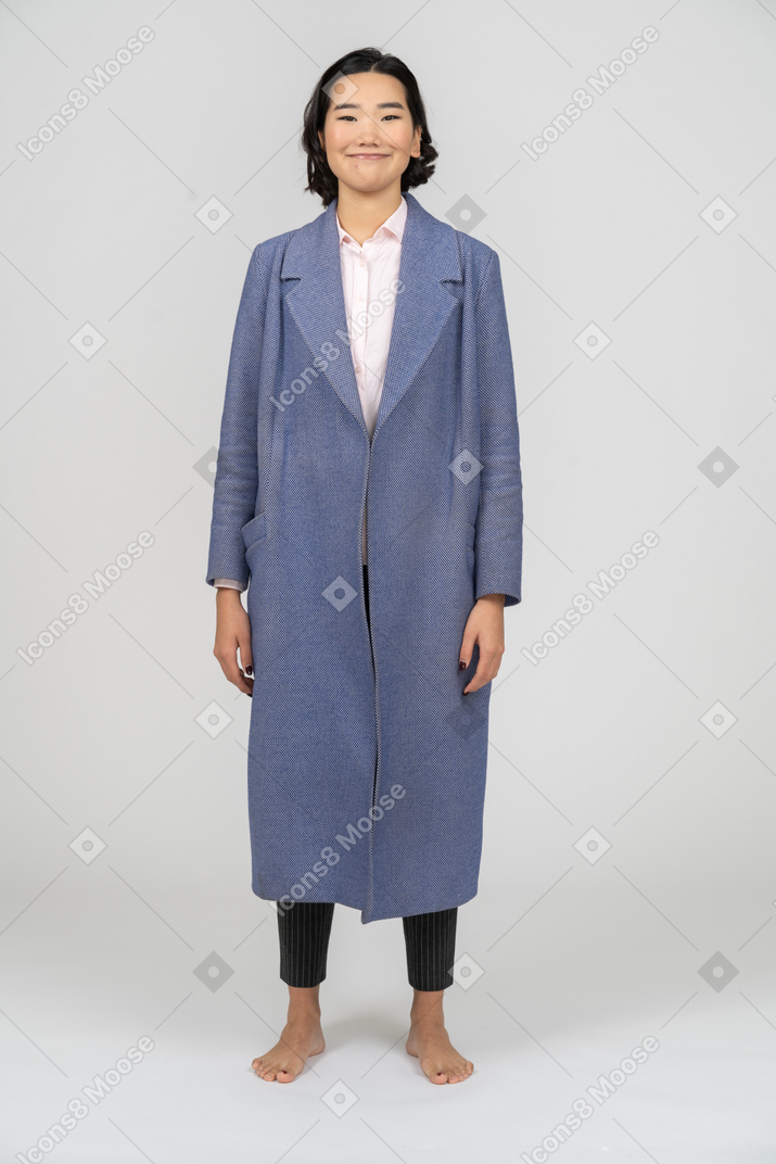 Woman in blue coat smiling cheerfully