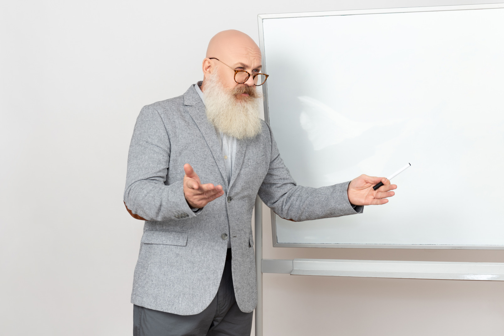 Old professor standind near whiteboard and pointing up with a merker