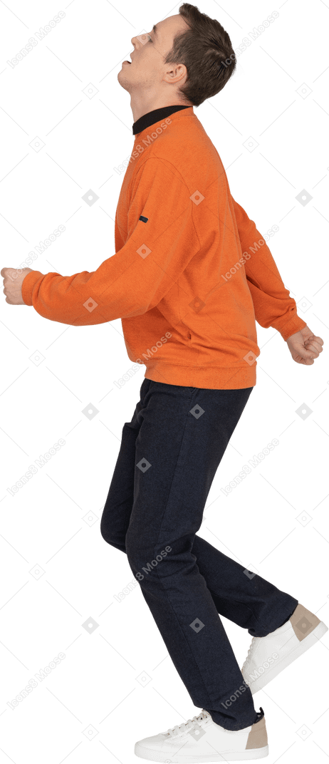 Young man in orange sweatshirt walking