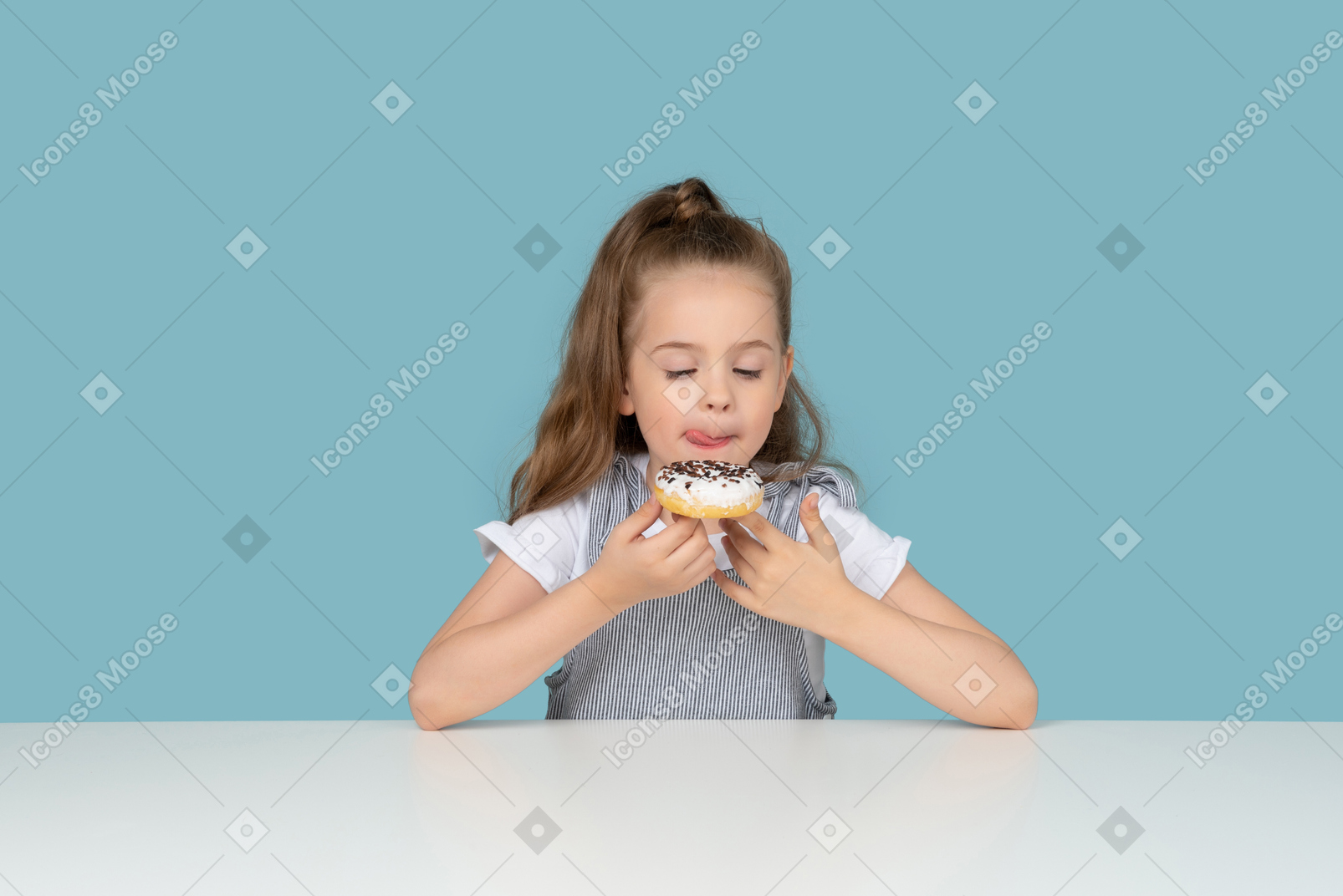 Cute little girl looking at a doughnut