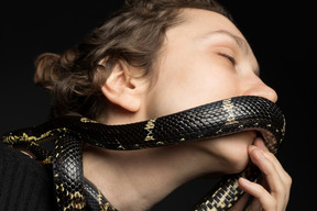 Cute woman kissing a snake