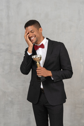 Happy man holding an award