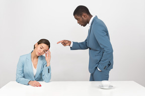 Attractive afroman pointing at his female coworker