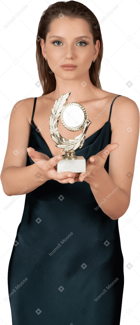 Vista frontale di una giovane donna grata in camicia da notte in possesso di un premio