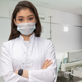 A woman wearing a face mask in a hospital