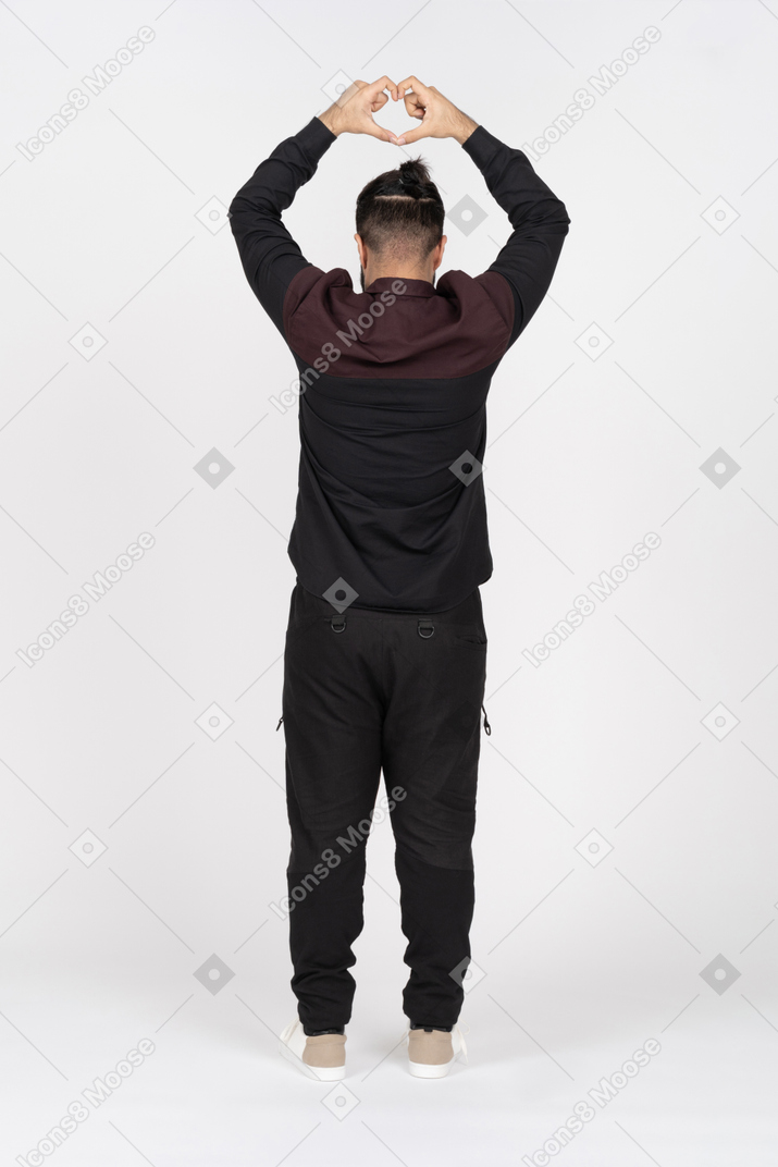 Back view of man with heart gesture above head