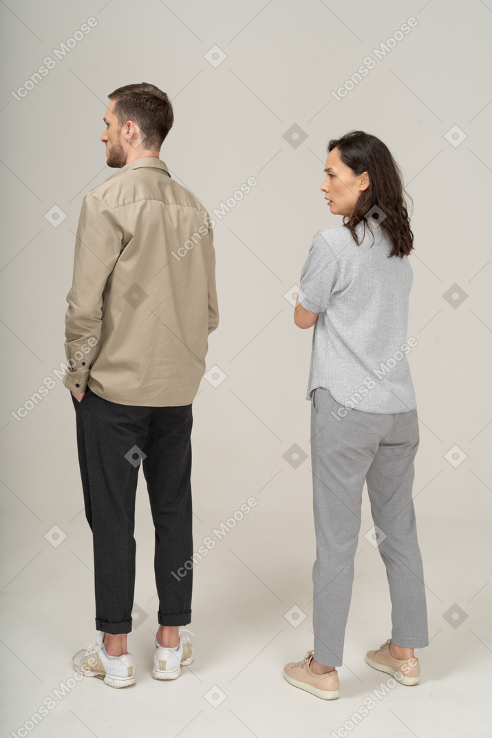 Three-quarter back view  of young couple being annoyed