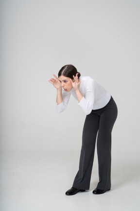 Front view of a woman in black pants making faces