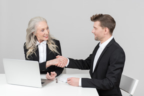 An older woman and a young man working together