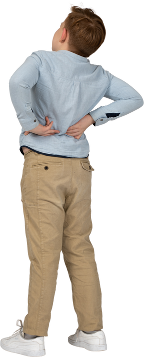 Back view of a boy standing with hands on back
