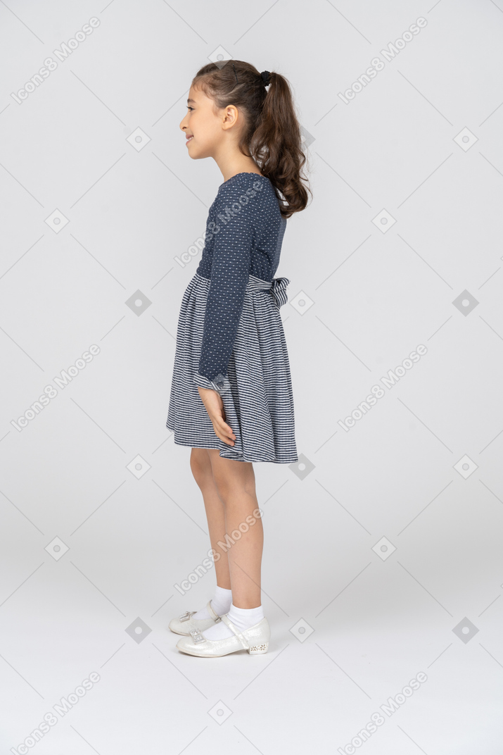 Side view of a girl slouching with a smile