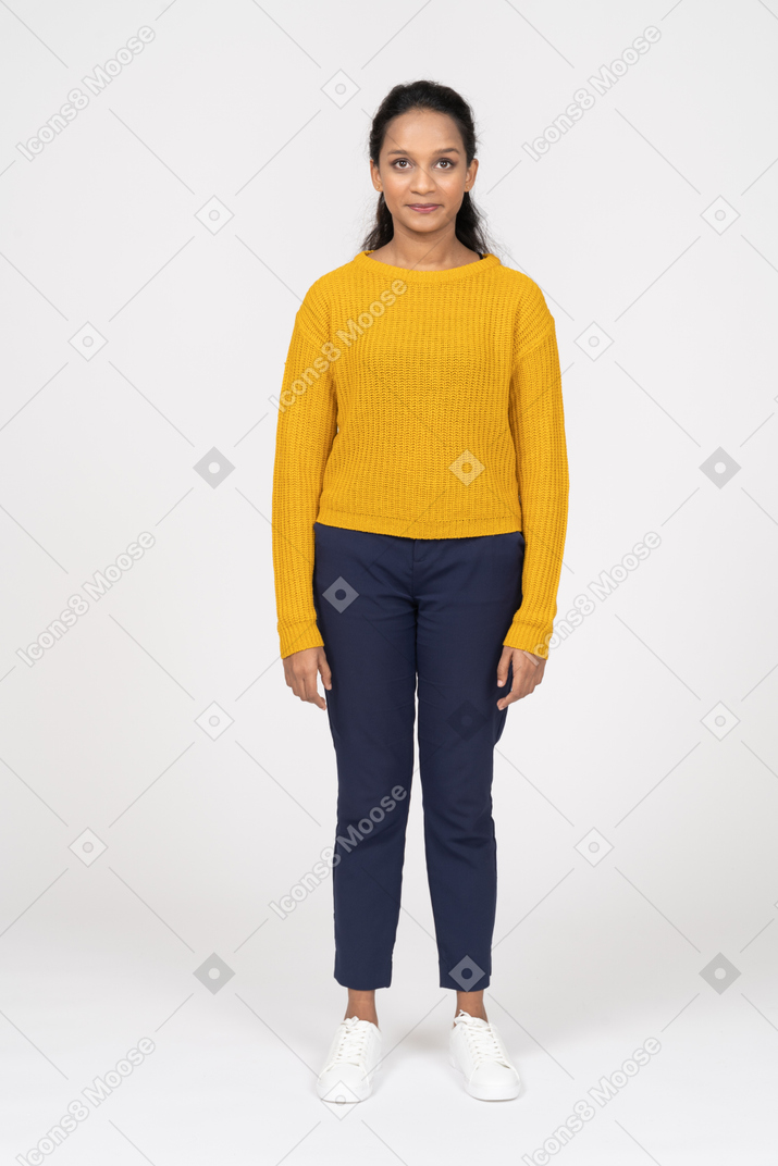 Front view of a beautiful girl in casual clothes looking at camera