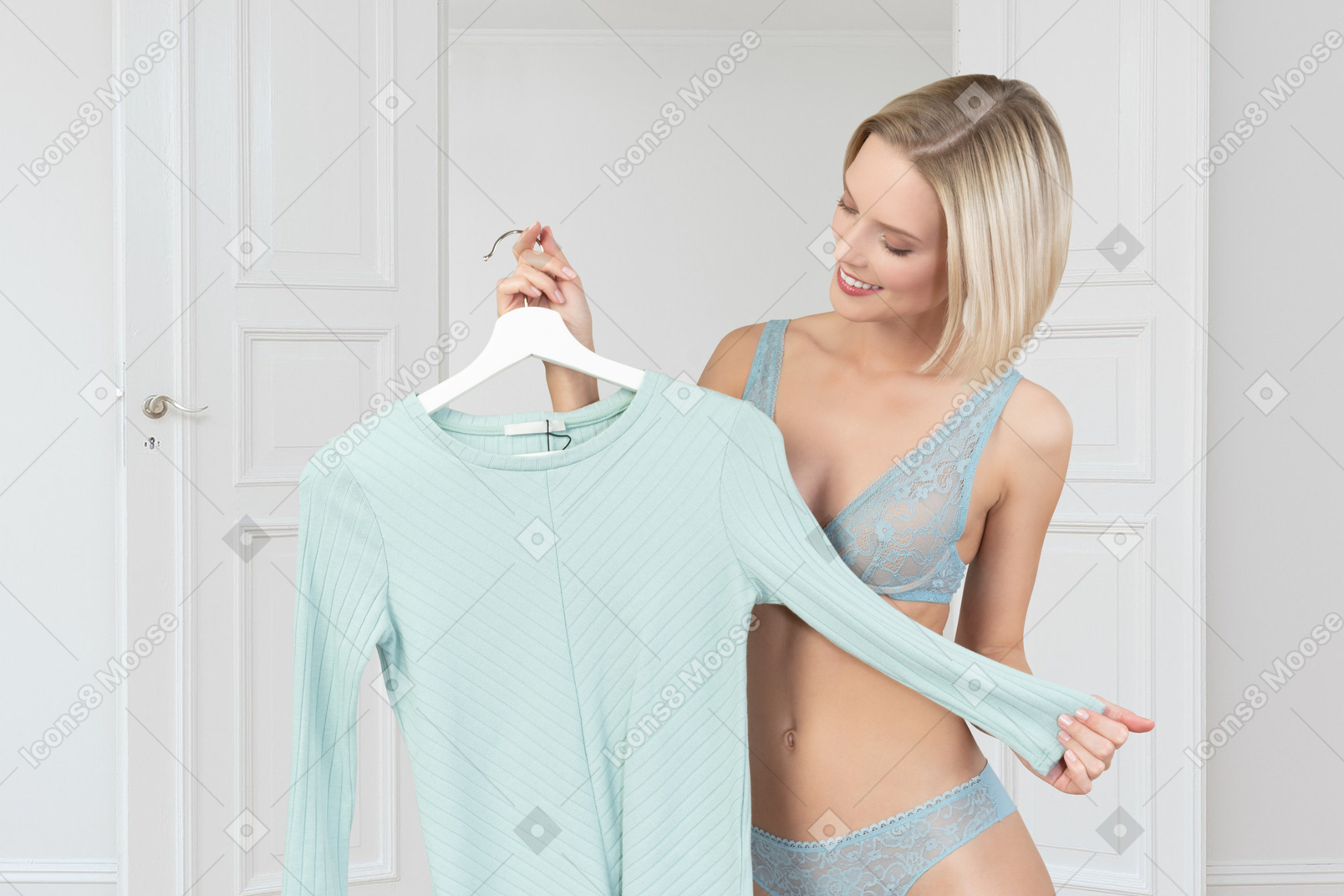 Woman in bra holding a shirt