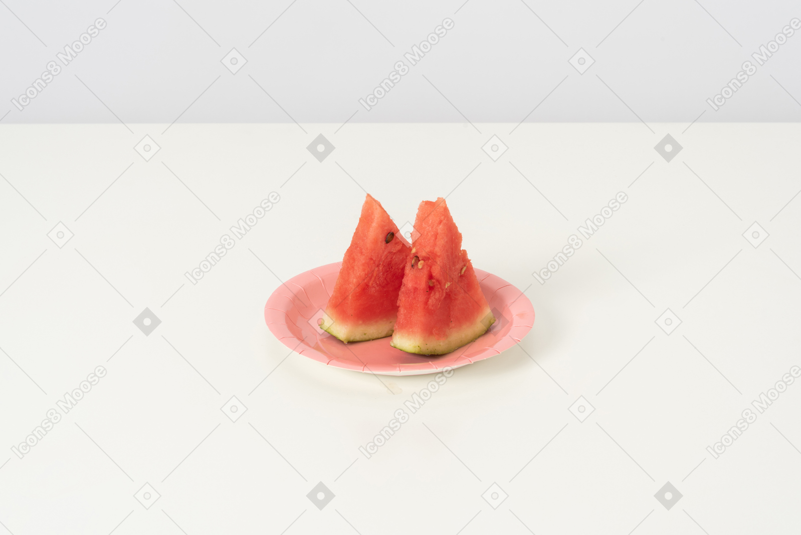 Two slices of a sweet ripe watermelon, lying isolated against a white background on a cute pink plate