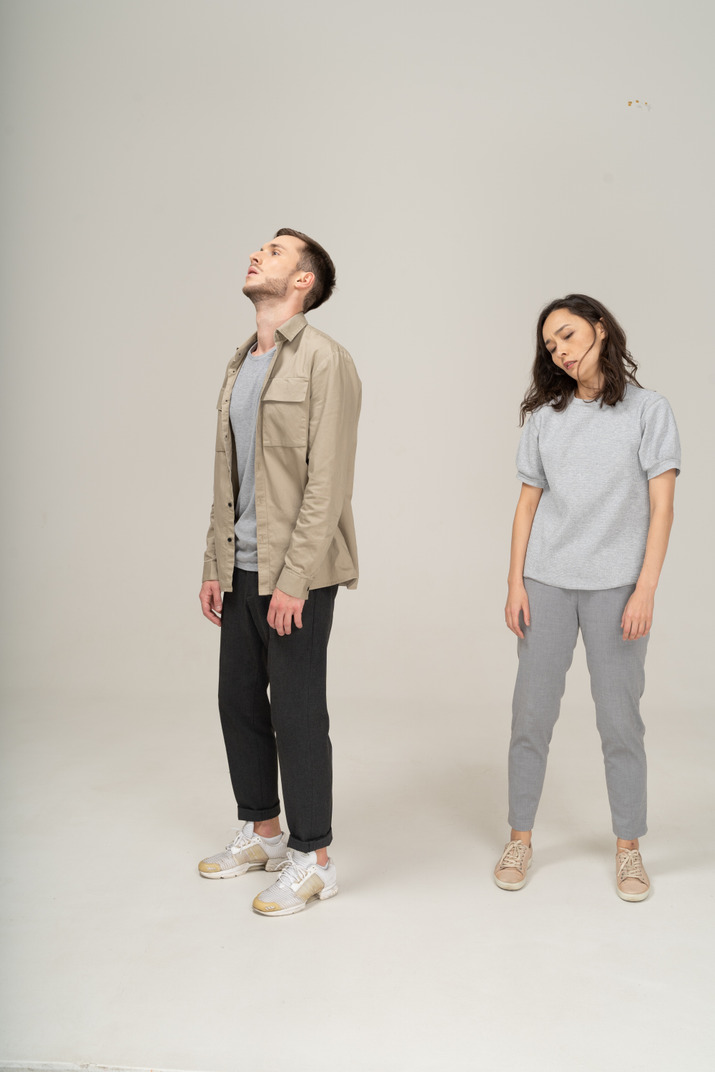 Young man and woman standing exhausted