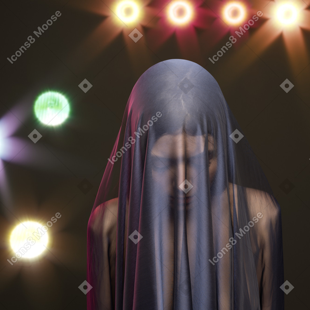 A woman with a veil on her head standing in front of a stage
