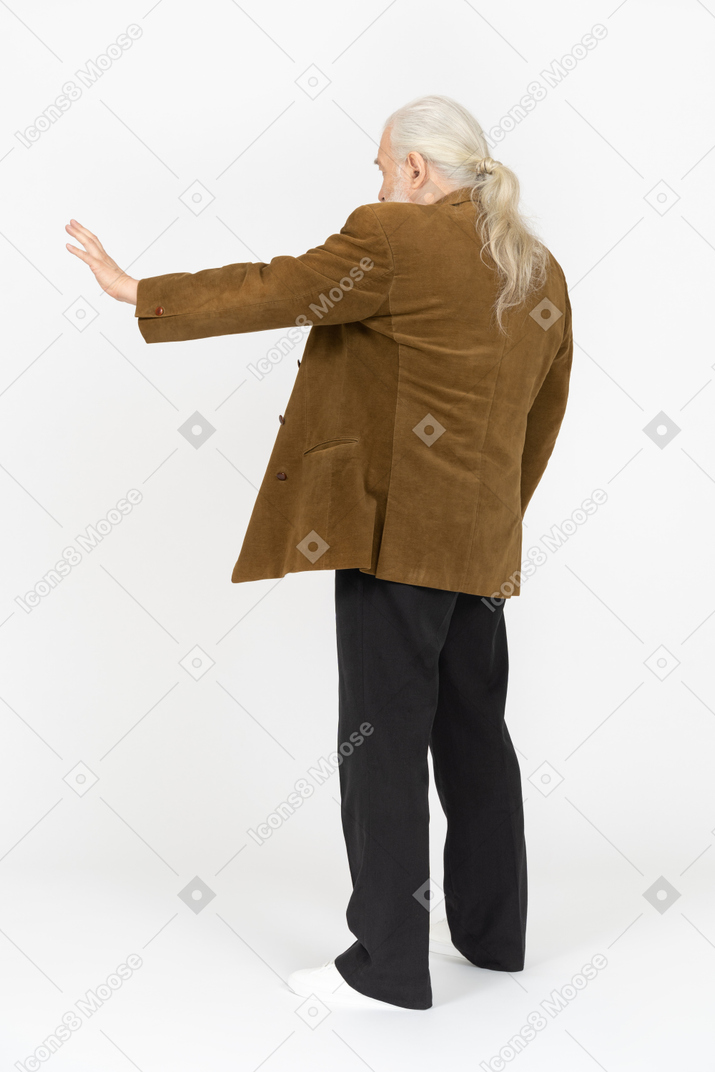 Elderly man making stop gesture