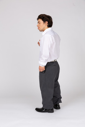 Profile view of an office worker standing with eyes closed