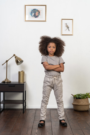 Good looking girl kid posing on the apartment background