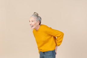 Elegant older woman in a mustard sweater