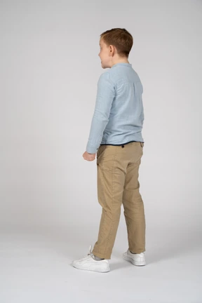 Side view of an angry boy with clenched fists