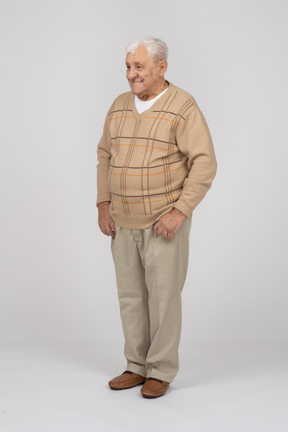 Front view of an old man in casual clothes standing still