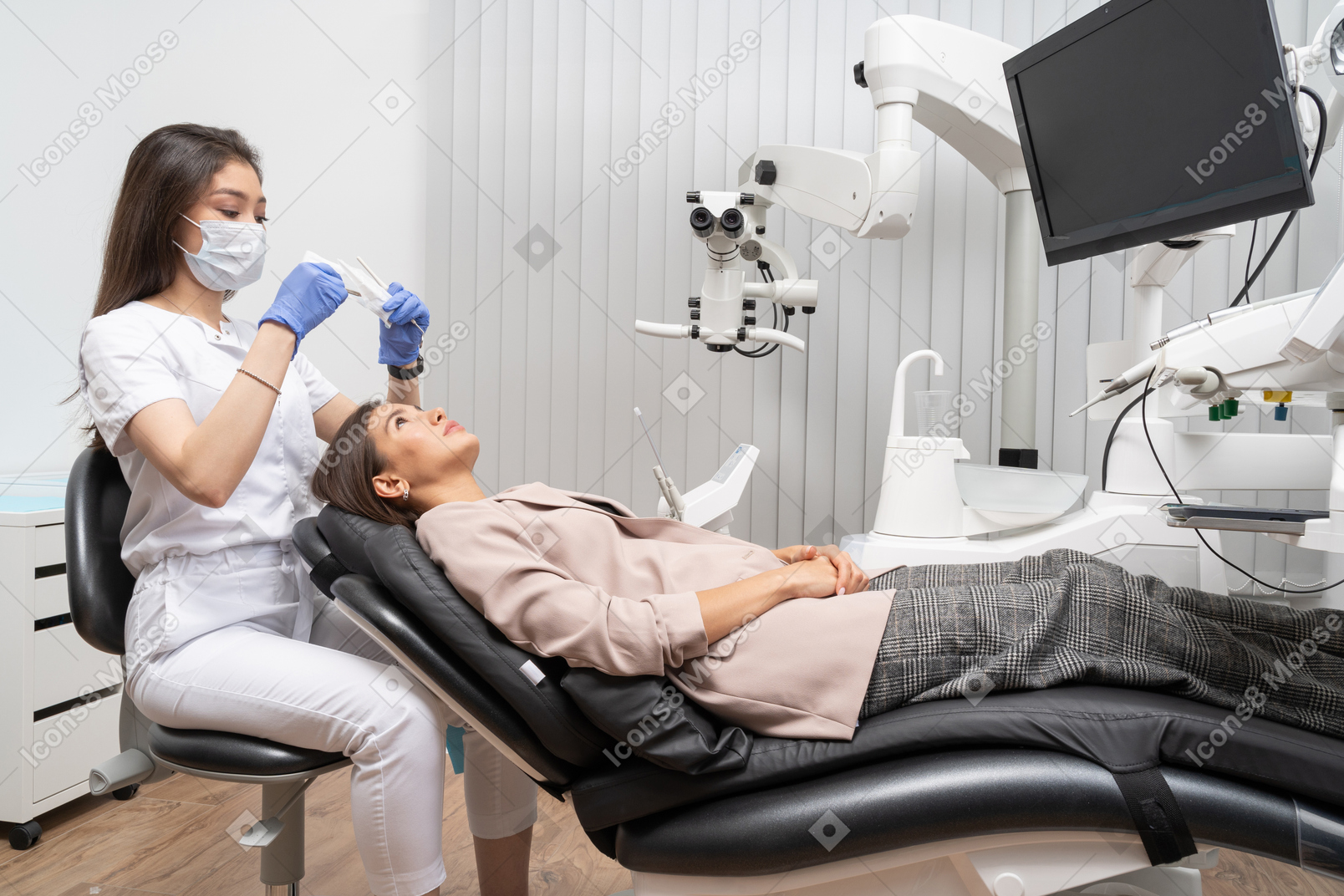 Full-length of a female dentist examining her patient