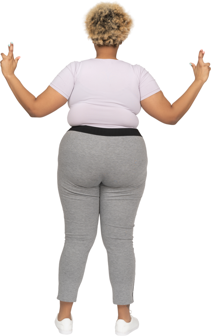 Plump woman keeping with fingers crossed back to camera
