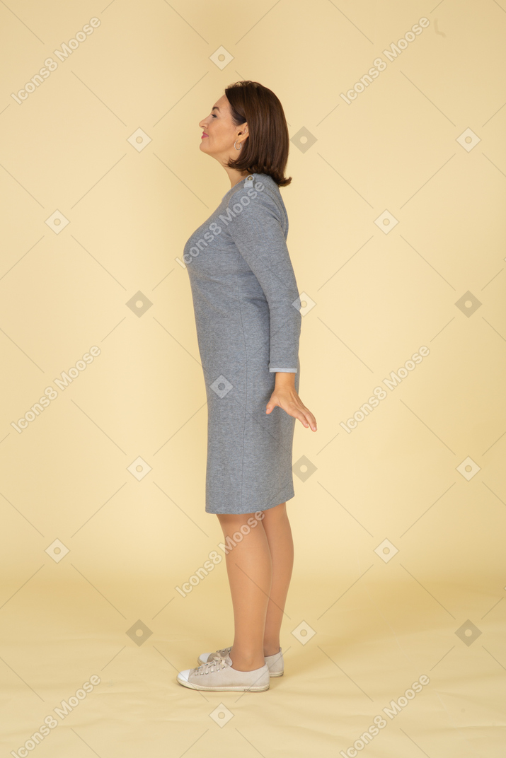 Side view of a woman in grey dress