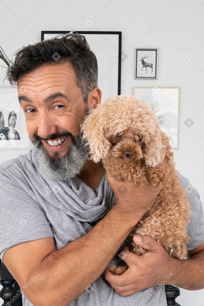 A man holding a dog in his arms
