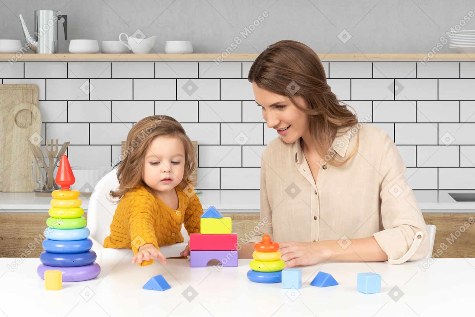A mother and her baby are playing with toys