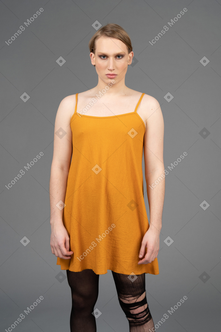 Front view of a transgender person in orange dress