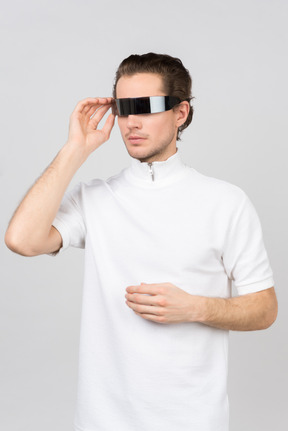 Young man adjusting futuristic eyewear