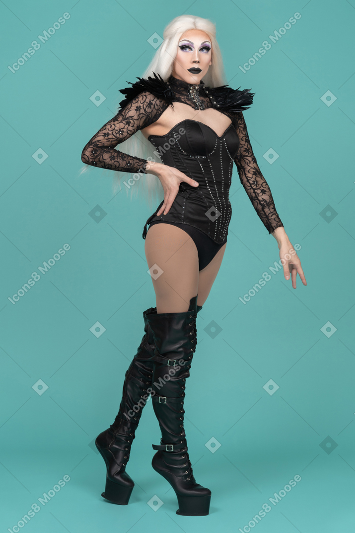 Transvestite posing with one hand on hip
